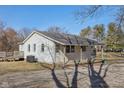 A cozy home with a covered porch and deck, surrounded by mature trees at 27 State Road 42 W, Mooresville, IN 46158