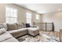 Bright living room featuring a comfortable sectional sofa, rug, and large windows for natural light at 307 Wakefield Way, Zionsville, IN 46077