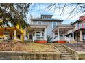 Traditional home featuring a cozy front porch, classic architectural elements, and a well-maintained yard at 342 N Arsenal Ave, Indianapolis, IN 46201