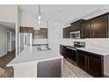 Modern kitchen features stainless steel appliances, a large island, and dark wood cabinetry at 4236 Stubbington Ln, Indianapolis, IN 46239