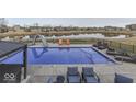This backyard features a large pool, a slide, lounge chairs, and a gazebo at 4268 Winners Cir, Bargersville, IN 46106
