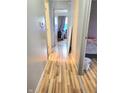 Hallway featuring hardwood floors and access to multiple rooms at 5212 Bahia Dr, Indianapolis, IN 46237