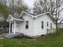 Cozy white house featuring well-maintained siding and a welcoming covered porch at 605 W 10Th St, Muncie, IN 47302