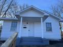 This home features a quaint covered porch, providing a welcoming entrance and curb appeal at 605 W 10Th St, Muncie, IN 47302