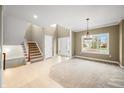 Bright, spacious living room with staircase, and large windows at 685 Greystone Ct, Columbus, IN 47201
