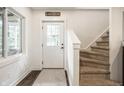 Light-filled foyer featuring carpeted stairs, a decorative door, and hardwood floors at 7082 Muskrat Dr, Nineveh, IN 46164