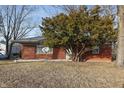 Charming brick ranch-style house with mature landscaping and a DirectTV satellite dish in the front yard at 8350 E Cr 200 S, Zionsville, IN 46077