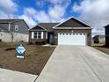 Charming single-story brick home featuring a two-car garage and well-manicured front lawn at 958 Mesa Ln, Bargersville, IN 46106