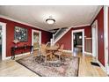 Inviting dining room featuring hardwood floors, a round table, and a staircase at 114 E Mill St, Brooklyn, IN 46111