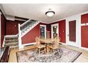 Inviting dining room featuring hardwood floors, a round table, and a staircase at 114 E Mill St, Brooklyn, IN 46111