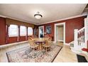 Inviting dining room featuring hardwood floors, a round table, and windows at 114 E Mill St, Brooklyn, IN 46111