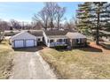 Attractive single-story home with a two-car garage, classic design and well-maintained lawn at 117 W Mckenzie Rd, Greenfield, IN 46140