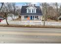 Inviting two-story home featuring a charming front porch, bright blue door, and a lovely white picket fence at 122 S Green St, Brownsburg, IN 46112