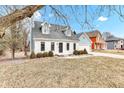 Beautiful home featuring a well-maintained lawn and mature trees, showcasing the property's charm at 12404 Doe Ln, Indianapolis, IN 46236