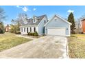 This exterior showcases a two-car garage, well-manicured lawn, and inviting curb appeal at 12404 Doe Ln, Indianapolis, IN 46236