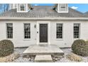 A close-up view of the front entrance, showing a solid door, neat landscaping, and well-lit entry at 12404 Doe Ln, Indianapolis, IN 46236