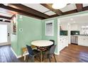 Cozy dining area with modern table and chairs, complemented by a stylish kitchen in the background at 129 N Sadlier Dr, Indianapolis, IN 46219