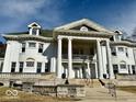 Close-up of home's elegant facade with grand columns and intricate architectural details at 1300 W University Ave, Muncie, IN 47303