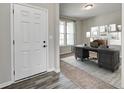 Inviting home office featuring a stylish desk, chair, decor, and lots of natural light from a large window at 13115 N Departure W Blvd, Camby, IN 46113