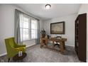Bright office with a wooden desk, grey curtains, a modern light fixture, and comfortable furnishings at 13115 N Departure W Blvd, Camby, IN 46113