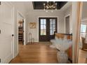 Elegant foyer featuring hardwood floors, a dark ceiling, and a grand entrance with double doors leading to the outside at 16392 Grand Cypress Dr, Noblesville, IN 46060