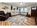 Comfortable living room with matching sofas, a patterned rug, and natural light at 1921 E State Road 42, Mooresville, IN 46158