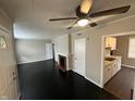 Inviting living room features black flooring, a ceiling fan, and a fireplace at 1925 N Leland Ave, Indianapolis, IN 46218