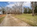 Long driveway and attached garage of this charming brick home with large front yard at 208 Northshore Blvd, Anderson, IN 46011