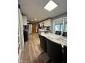 Eat in kitchen features a marble dining table, island, and sliding glass doors for access to the patio at 304 Griffin Rd, Indianapolis, IN 46227