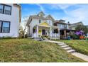 Two-story home with inviting front porch and lush green lawn on a bright day at 3145 N New Jersey St, Indianapolis, IN 46205