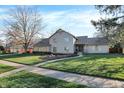 Inviting two-story house with well-manicured lawn, mulch beds, and a stone walkway at 3517 Brumley Way, Carmel, IN 46033