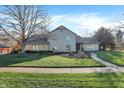 Attractive two-story home featuring lush lawn, stone accents, and a paved walkway at 3517 Brumley Way, Carmel, IN 46033