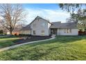 Classic home boasts a well-kept lawn, stone details, and a welcoming walkway at 3517 Brumley Way, Carmel, IN 46033