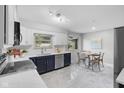 Well-lit kitchen with white cabinets, stainless steel appliances, and a cozy dining area at 44 Kessler Blvd W Dr, Indianapolis, IN 46208