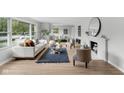 Bright living room with modern decor, large windows, and wood-style flooring at 44 Kessler Blvd W Dr, Indianapolis, IN 46208