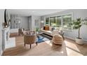 Sunlit living room features a large window, comfortable seating, and modern decorative elements at 44 Kessler Blvd W Dr, Indianapolis, IN 46208