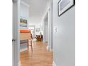 Hallway with hardwood floors, decorative columns, and views into the living room at 450 E Ohio St # Apt 118, Indianapolis, IN 46204