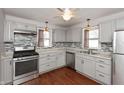 Modern kitchen featuring stainless steel appliances, light gray cabinets and elegant backsplash at 518 E College Ave, Brownsburg, IN 46112