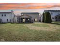 Expansive backyard featuring a well-maintained lawn and a screened-in porch for outdoor enjoyment at 5546 W Vistaview Trl, McCordsville, IN 46055