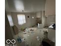 A distressed kitchen featuring sparse white cabinetry needing rehabilitation at 5834 42Nd St, Indianapolis, IN 46226