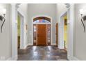 Elegant foyer featuring a wooden front door, slate floors, and tasteful wall decor at 5895 W 265 N, Columbus, IN 47201