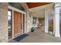 Inviting front porch with stone columns and a relaxing swing, ideal for enjoying the outdoors at 5895 W 265 N, Columbus, IN 47201