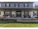 Welcoming front porch with comfortable seating, decorative accents, and a charming entrance at 7089 W 150 N, Greenfield, IN 46140