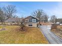 Charming two-story home with stone accents, blue siding, and a long driveway at 12166 Bray Rd, Mooresville, IN 46158