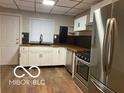 Modern kitchen boasts stainless steel appliances, sleek countertops, and ample cabinetry at 1220 E Second St, Greenfield, IN 46140