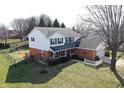 Beautiful home with a fenced yard and mature trees surrounding the property at 12225 Sunrise Dr, Indianapolis, IN 46229