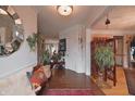 Inviting foyer with hardwood floors, bench seating, decorative mirrors, and stylish decor at 12695 Vanderhorst St, Carmel, IN 46032