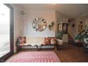 Spacious foyer featuring hardwood floors, bench with pillows, and a round decorative mirror at 12695 Vanderhorst St, Carmel, IN 46032