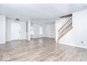 Spacious living room with modern flooring, neutral walls, and bright natural light at 12884 Courage Xing, Fishers, IN 46037