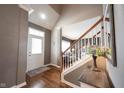 Inviting foyer featuring hardwood floors, staircase, and stylish decor leading to the living area at 15542 Crofton Pl, Westfield, IN 46074